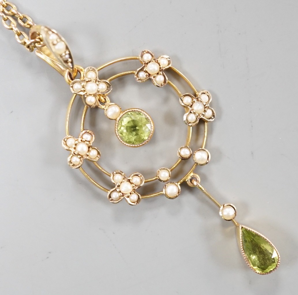 An Edwardian 9ct, peridot and seed pearl cluster set drop pendant necklace, pendant 49mm, chain 45cm